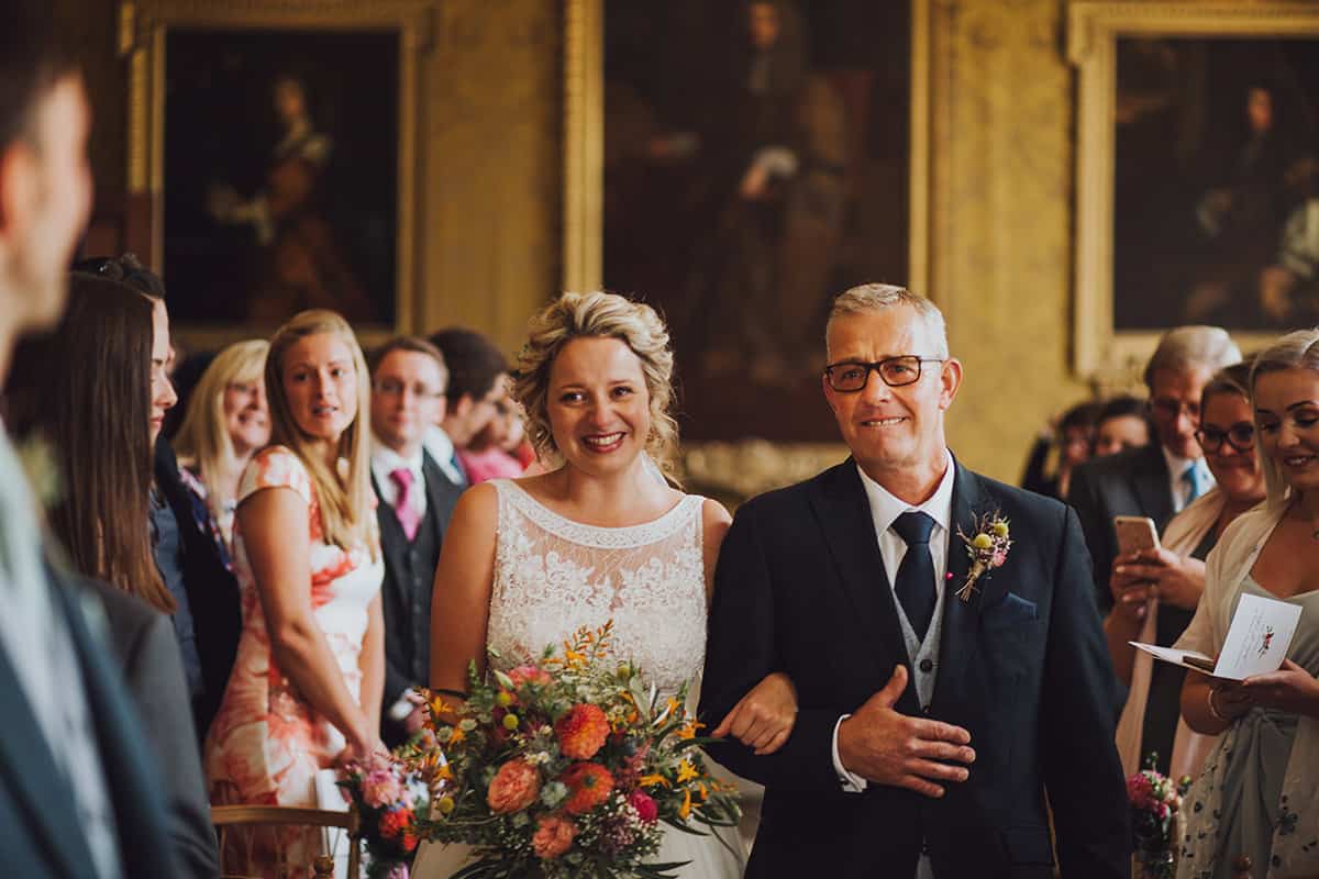 bride walks down the aisle with her dad