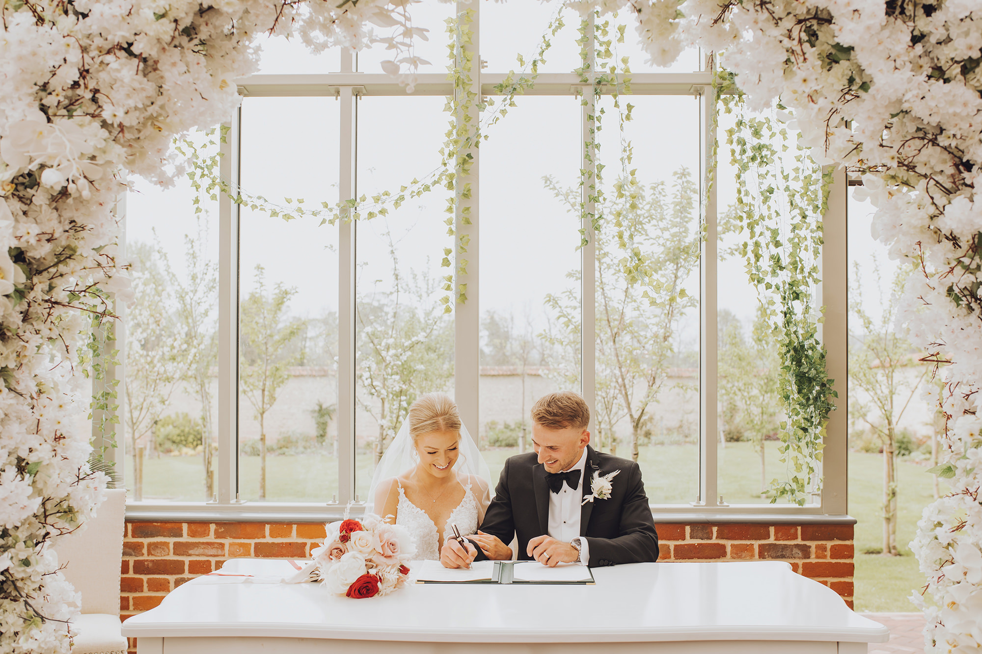 newlyweds sign the marriage certificate at syrencot