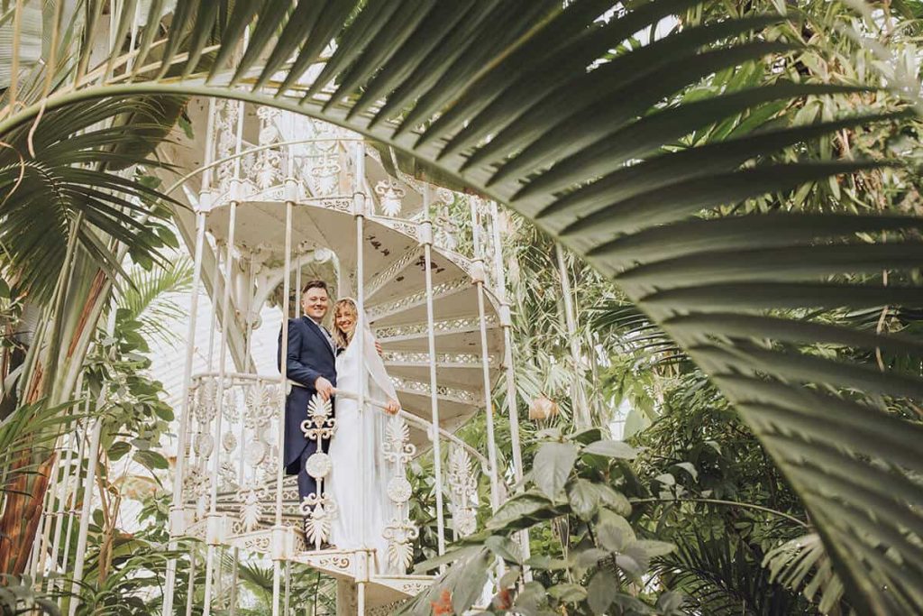 wedding couple at kew gardens on spiral staircase in conservatory