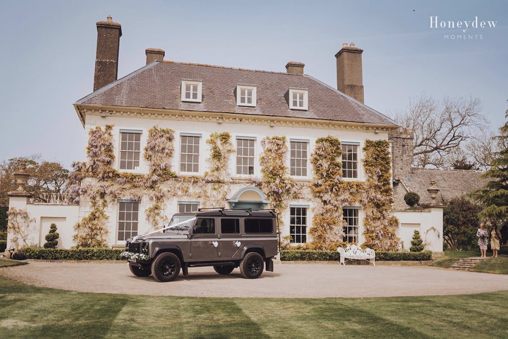 a grey landrover parked outside gileston manor