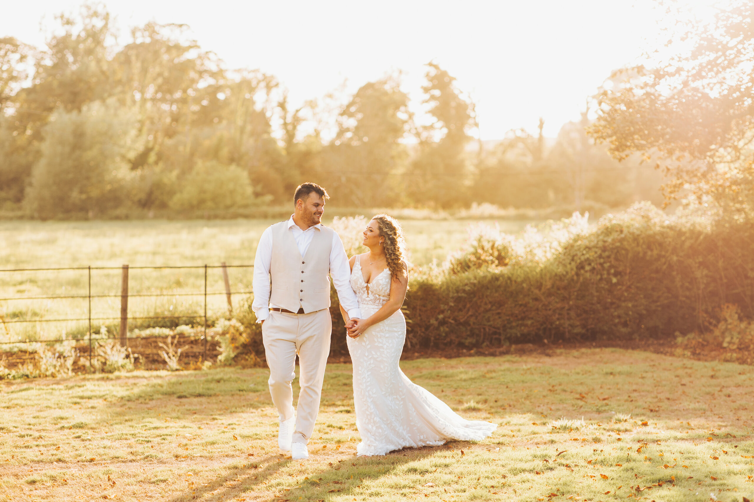 married couple walking through the sunset at syrencot