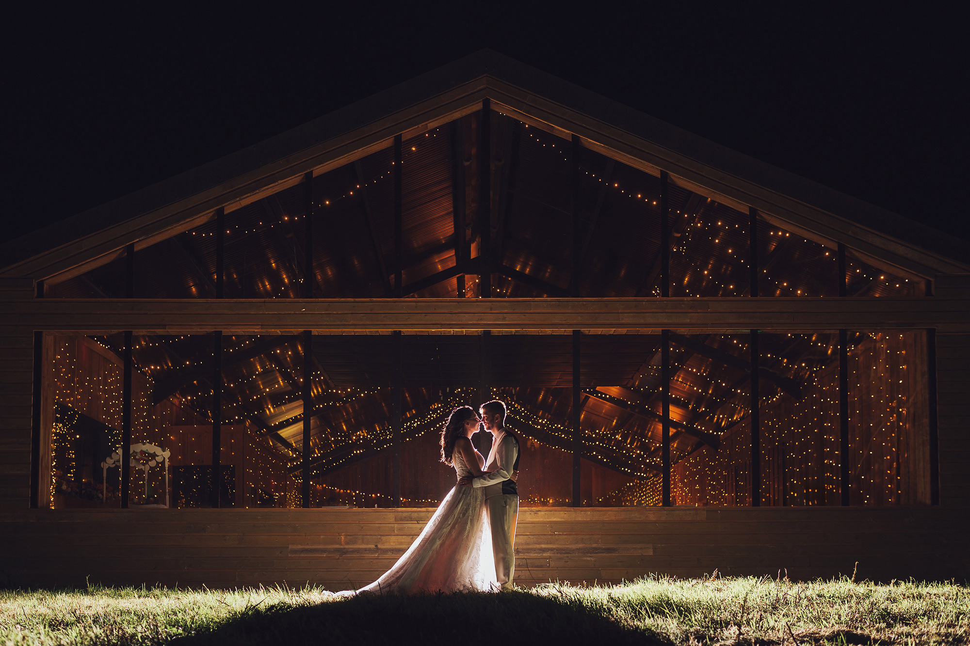 chafford park estate fairylights inside the barn create a gorgeous backdrop for our backlit wedding couple